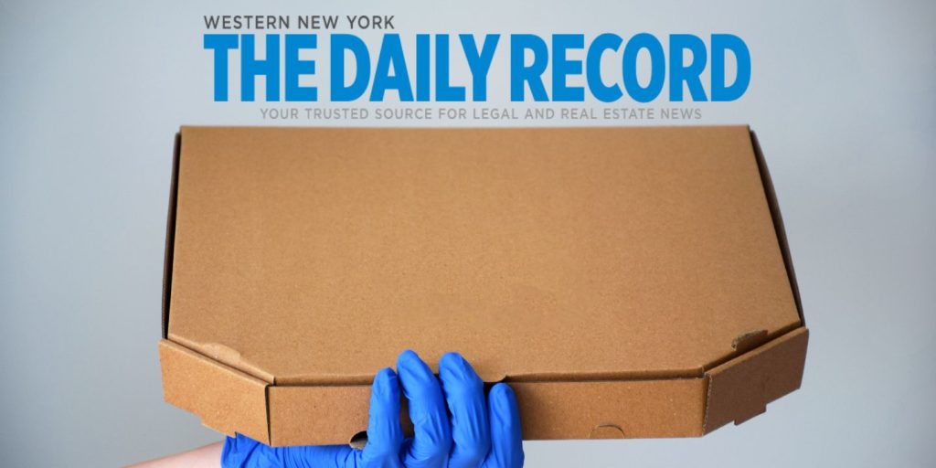 Pizza box image being held out by a delivery person with logo of Daily Record